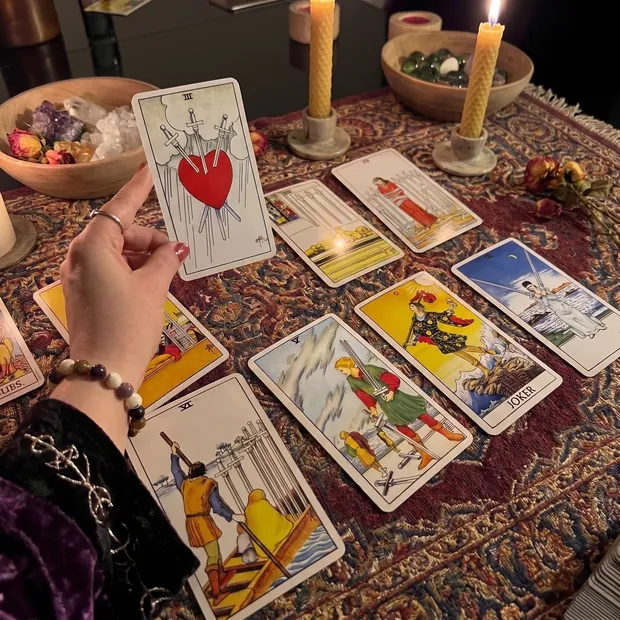 A tarot spread laid out on a table by candlelight